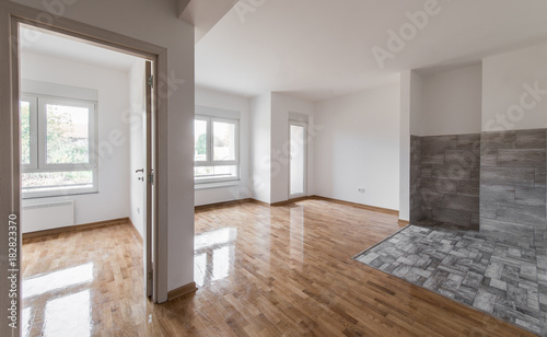 Empty apartment with walls and wooden floor