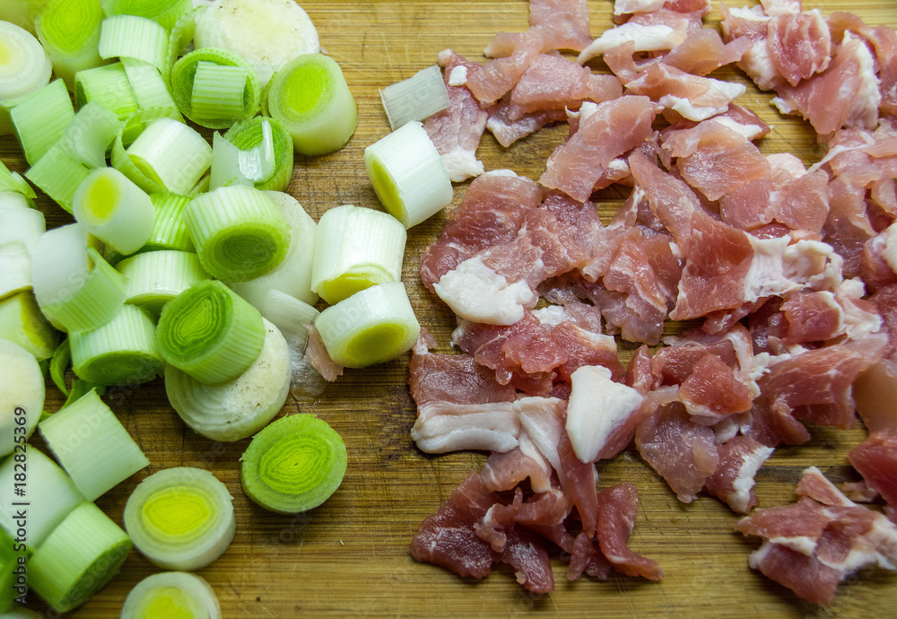Chopped bacon and leeks on a cutting board