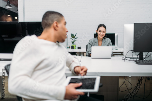 multiethnic young business partners talking at office