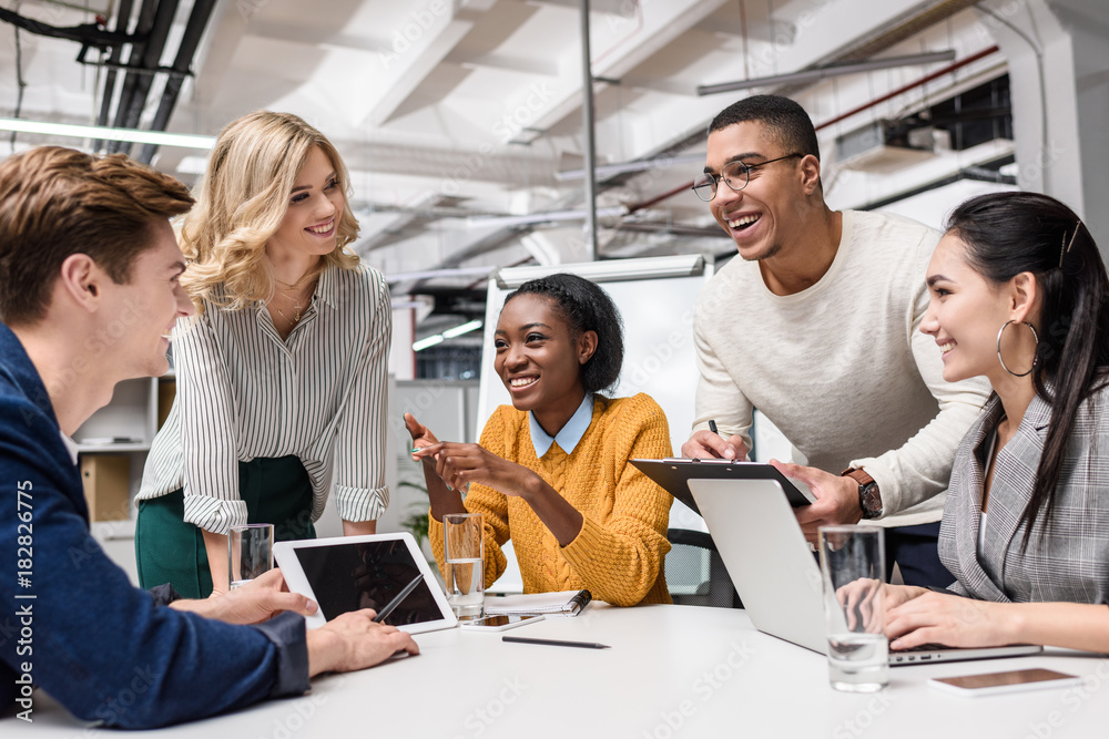 young happy managers working together at conference hall in modern office