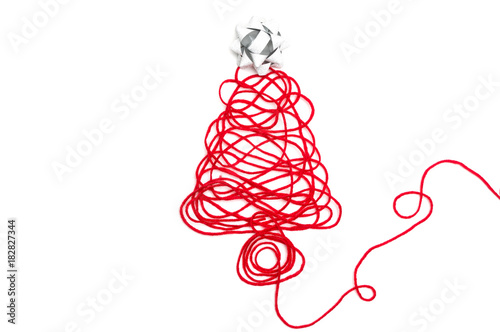 A tree made of red thread and ribbon on white background