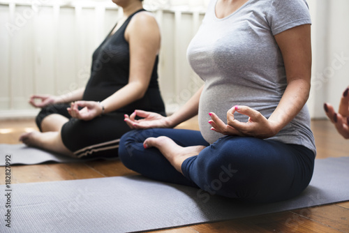 Pregnant woman in yoga class
