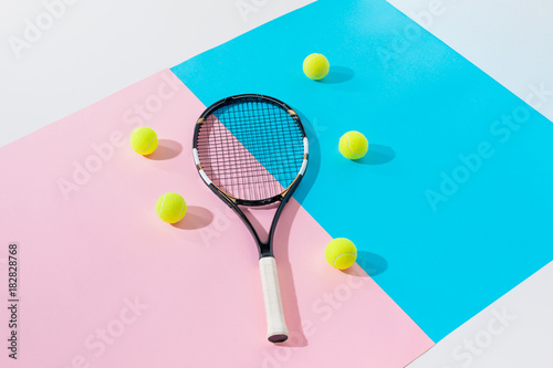 tennis racket and yellow balls on blue and pink papers © LIGHTFIELD STUDIOS