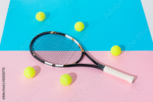 tennis racket and yellow balls on blue and pink papers © LIGHTFIELD STUDIOS