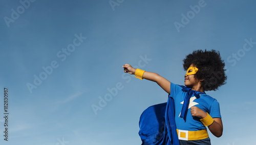 Girl with afro playing superhero