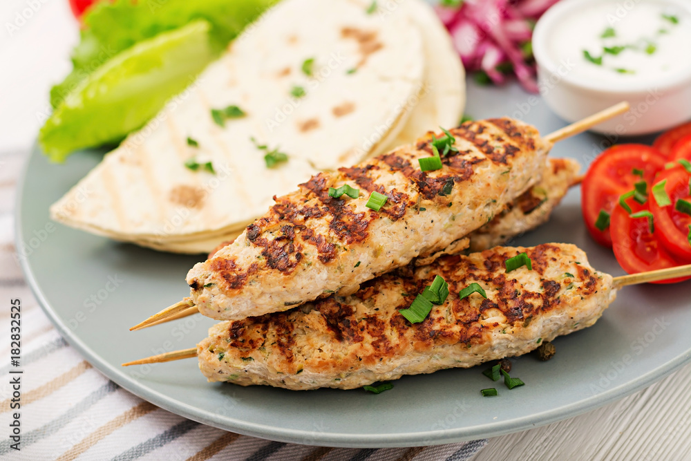 Minced Lula kebab grilled turkey (chicken) with fresh vegetables.