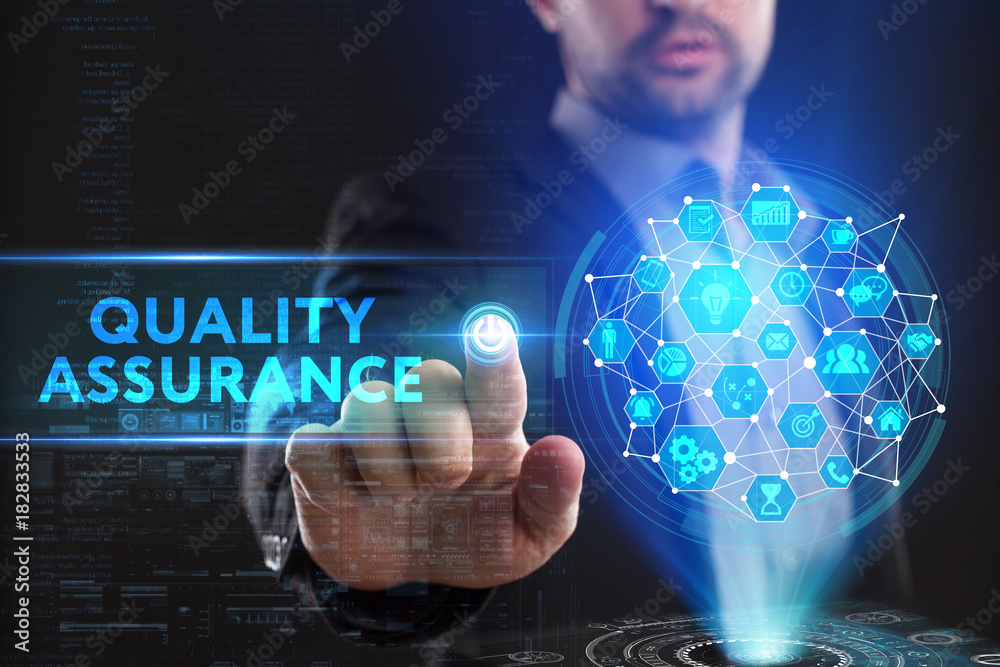 The concept of business, technology, the Internet and the network. A young entrepreneur working on a virtual screen of the future and sees the inscription: Quality assurance The concept of business, technology, the Internet and the network. A young entrepreneur working on a virtual screen of the future and sees the inscription: Quality assurance
