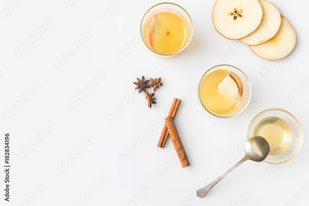 top view of glasses of apple cider with spices isolated on white top view of glasses of apple cider with spices isolated on white
