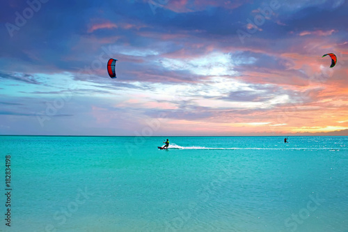 Kite surfing at Aruba island in the caribbean sea at sunset