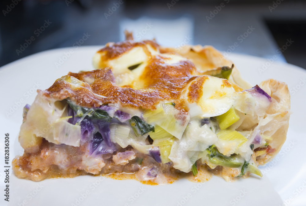 Quiche with vegetables, egg, bacon, chicken and cheese