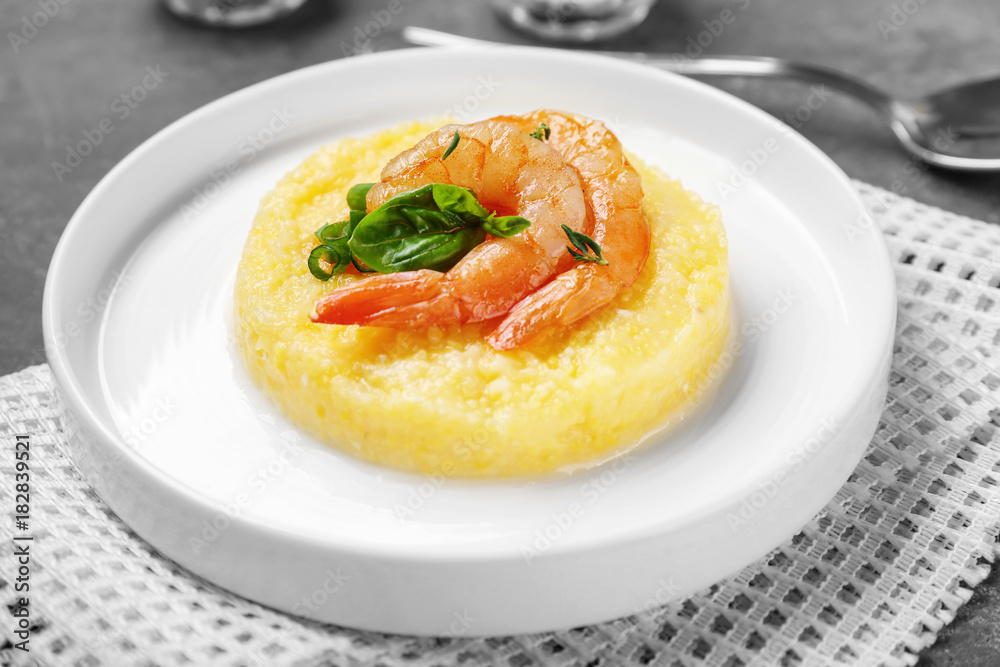 Plate with fresh tasty shrimp and grits on table, closeup