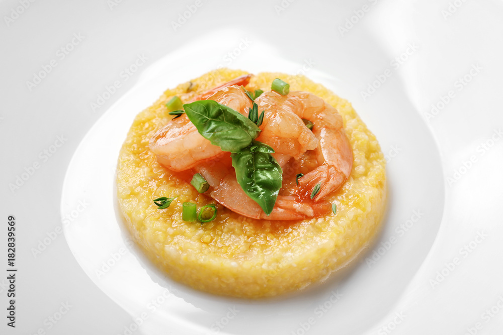 Fresh tasty shrimp and grits on plate, closeup Fresh tasty shrimp and grits on plate, closeup
