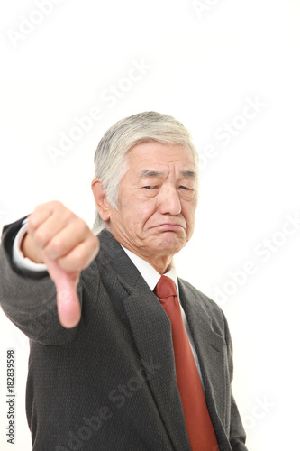 senior Japanese businessman with thumbs down gesture