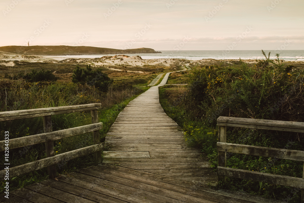 Naklejka premium Wooden promenade in Frouxeira beach