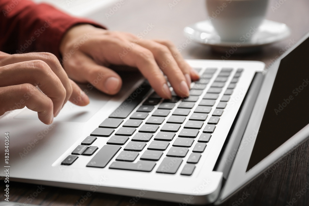Man using laptop on table, closeup Man using laptop on table, closeup