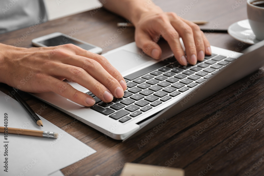 Man using laptop on table, closeup Man using laptop on table, closeup