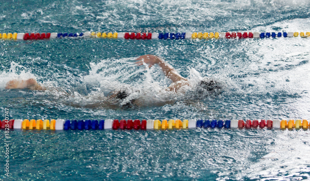 boy goes in for sports in the pool