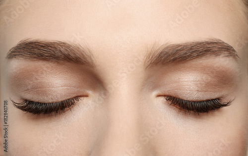 Closed female eyes with long eyelashes, closeup