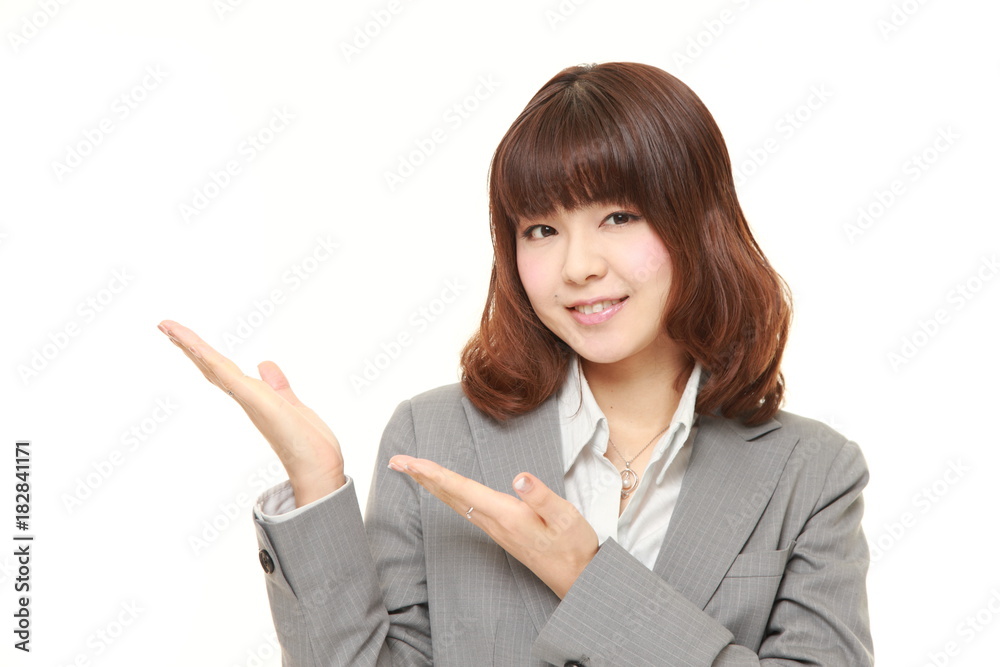 young Japanese businesswoman presenting and showing something young Japanese businesswoman presenting and showing something
