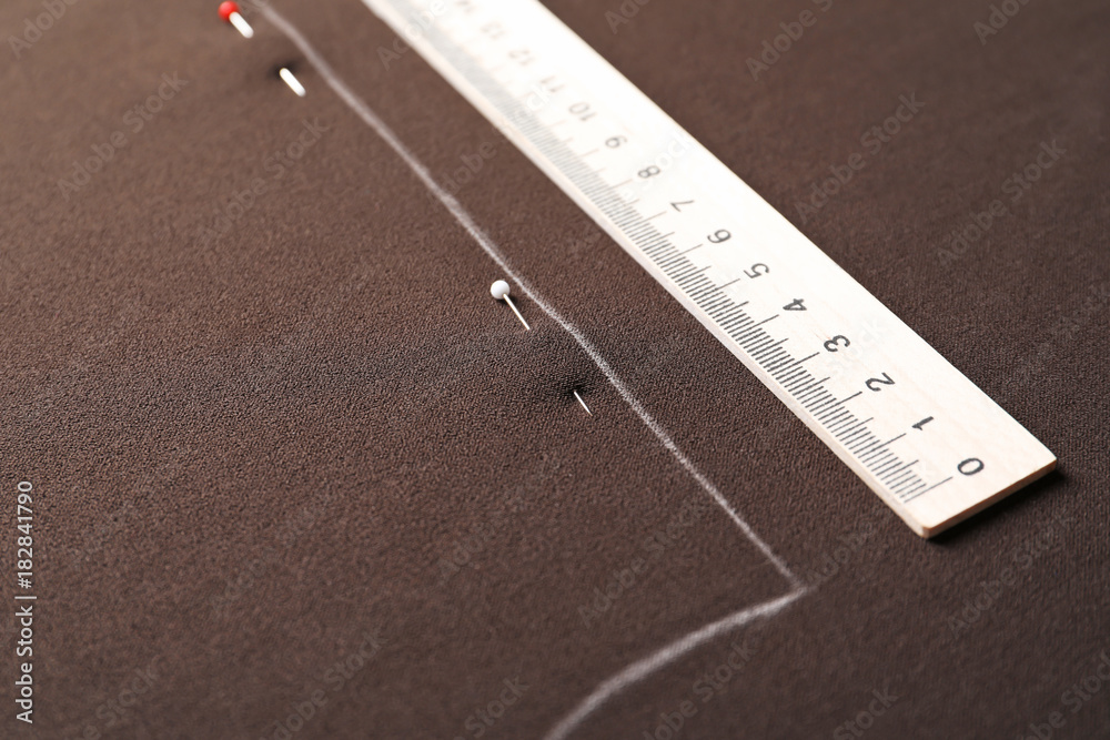 Fototapeta premium Fabric with pattern template and ruler, closeup