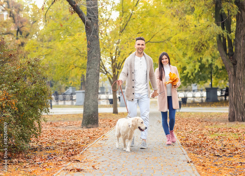 Young couple walking their ...