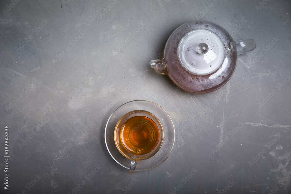 Cup with green tea on grey wooden background