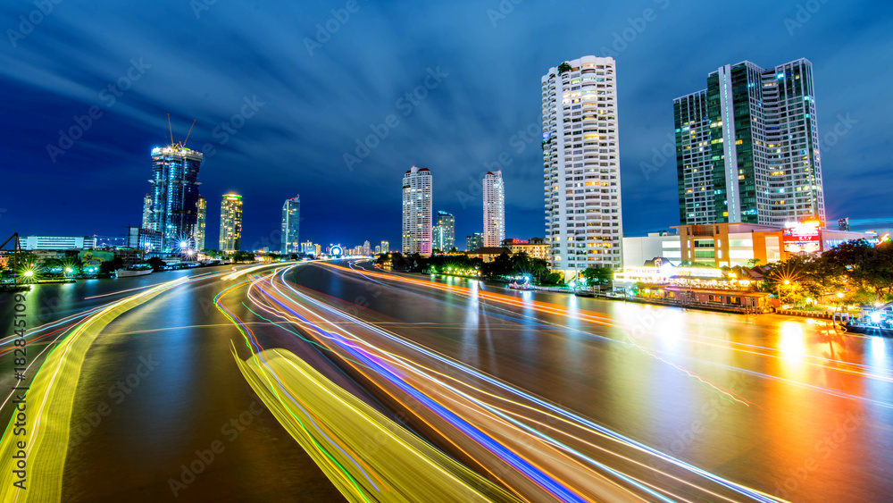 Fototapeta premium Bangkok city - Beautiful sunset curve Chao Phraya River long exposure light Cityscape urban of Bangkok city at night , panorama landscape Thailand