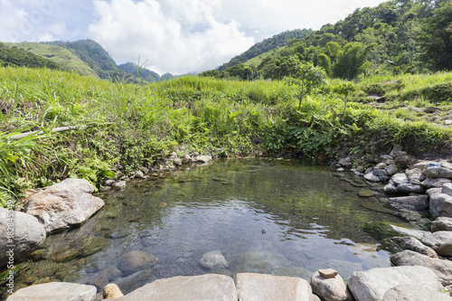  Kolo Rongo hot spring surrounded by rice fields at the foot of the Kelimutu National Park in Indonesia. photo