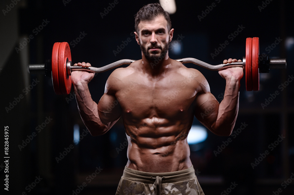 Brutal strong bodybuilder athletic men pumping up muscles with dumbbells.