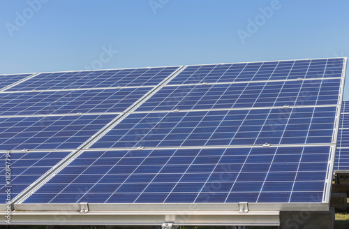 rows array of polycrystalline silicon solar cells in solar power plant turn up skyward absorb the sunlight from the sun 