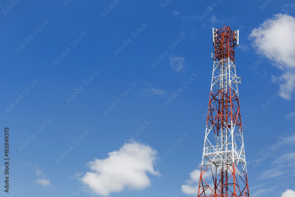 High antenna tower pillar of cellular communication on the blue sky background High antenna tower pillar of cellular communication on the blue sky background