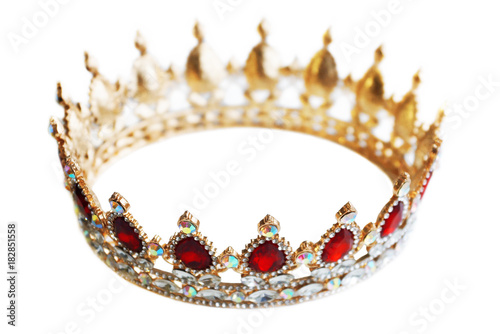 Golden crown with precious stones. Gold, sapphires and diamonds, red and white jewelry. Decoration for king or queen, magic crown isolated on white background, close up