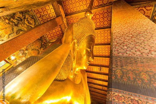 Reclining golden buddha inside pagoda at Wat Pho photo