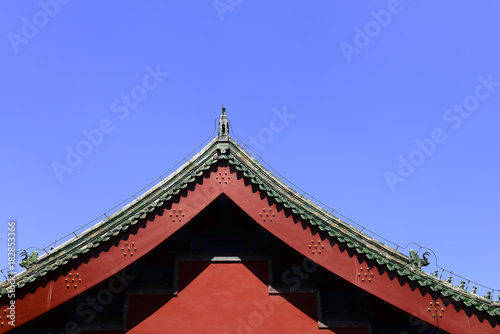 A corner of an ancient building under a blue sky