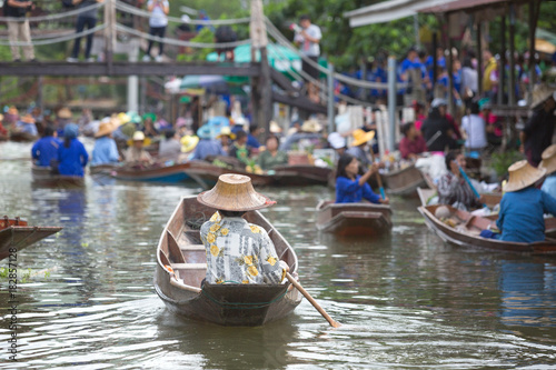 old lady boating to trade food in floating market