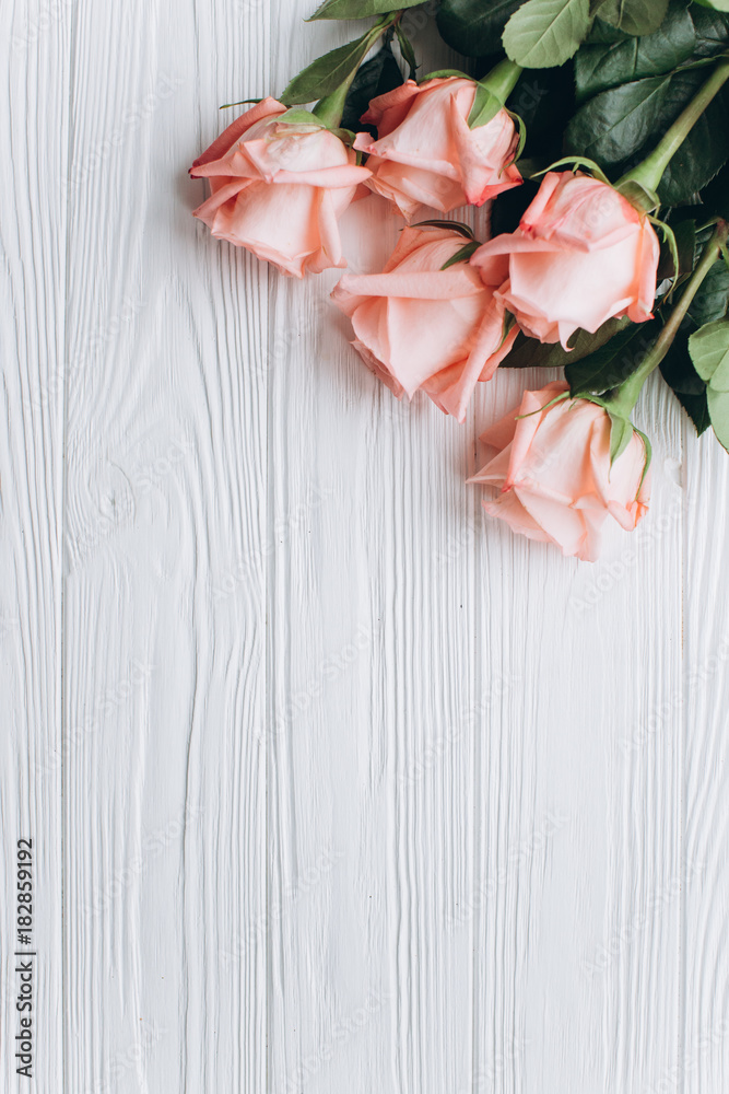 Fototapeta premium A white wooden board with pink roses.