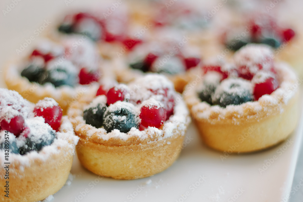 Tartlets with blueberries and raspberry. Small tarts with fruits. Tartlets with blueberries and raspberry. Small tarts with fruits.