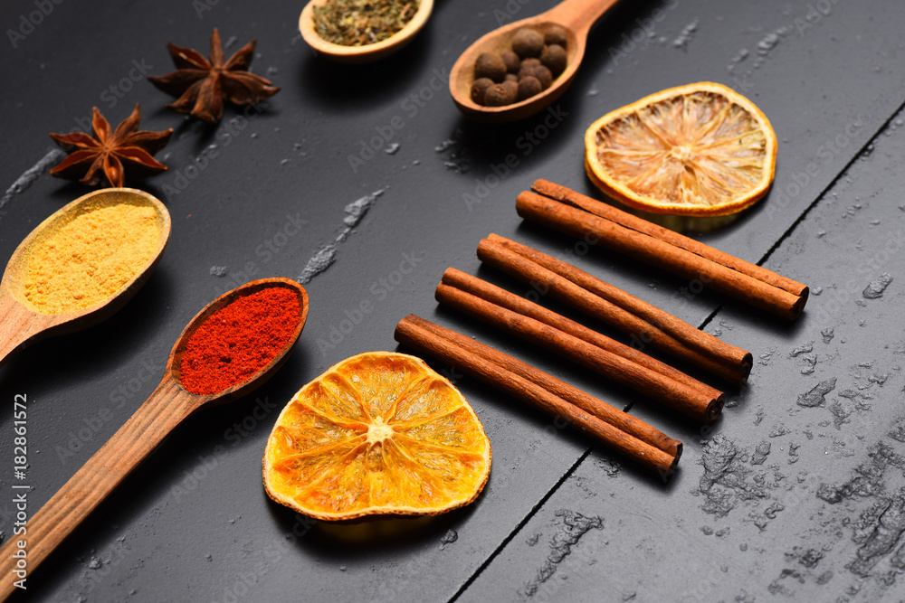 Composition of condiment. Set of spices on dark grey background.