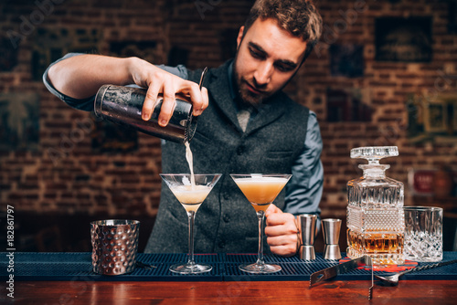 Barman creating professional cocktails. Details of alcoholic drinks and beverages at pub or bar