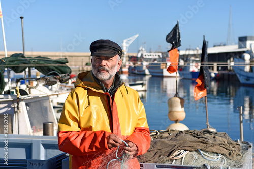 Fotografia, Obraz portrait of a fisherman in the harbor