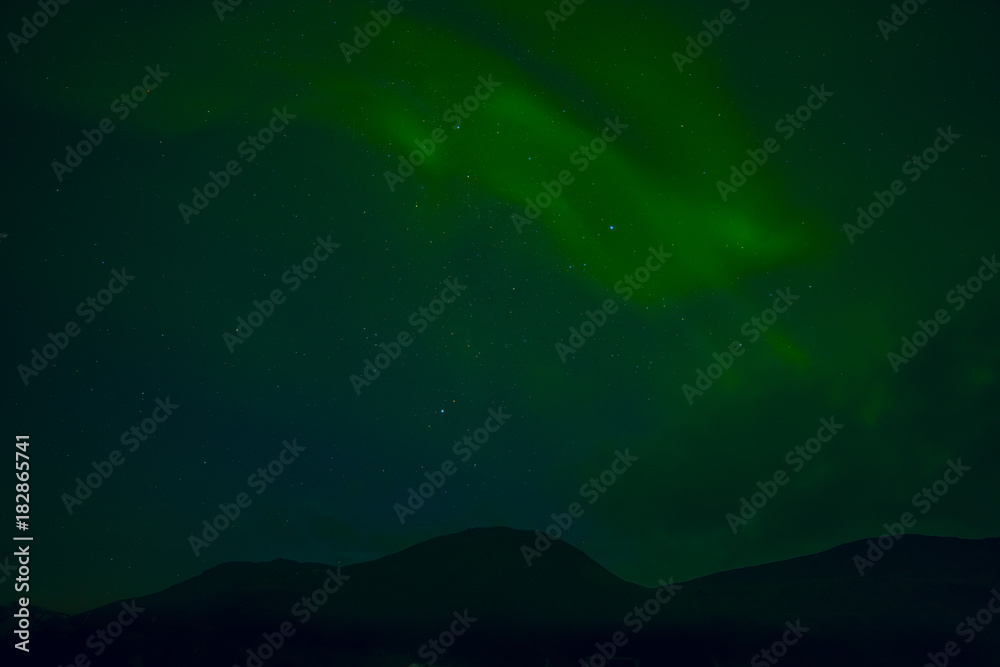 Night photo. Silhouette of the mountain and the northern lights.Iceland.
