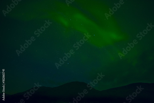 Night photo. Silhouette of the mountain and the northern lights.Iceland.  