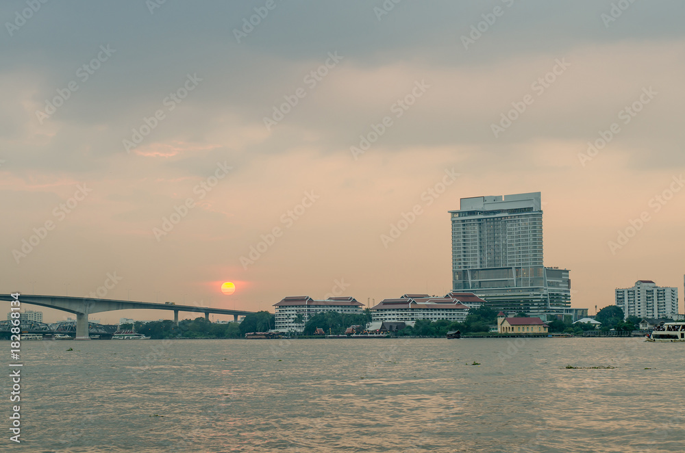 Landscape of Bangkok and Jao Phra Ya river, urban with sunset and reflection for background, wallpaper and space copy