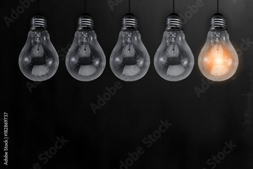 creativity ideas text with glow light bulb on black chalk board with free copy space for your ideas text photo