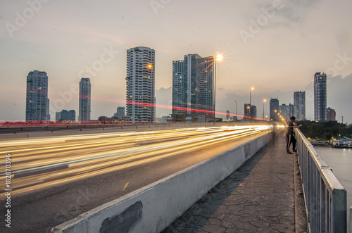 Evening view from Taksin Bridge of Sathon District. Below the bridge the Sathorn pier offers the service of Chao Phraya Express boats and ferry.