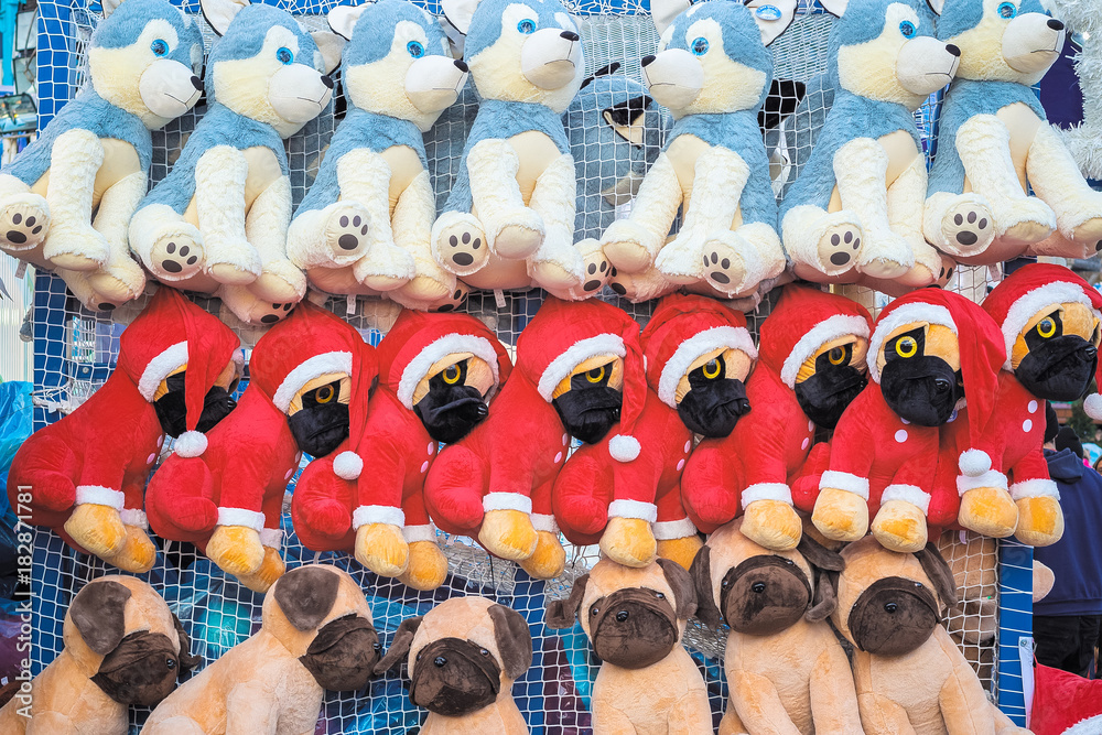 Stuffed toy dogs in Christmas theme on display awarded as wining prizes in  Christmas funfair winter wonderland Stock Photo | Adobe Stock