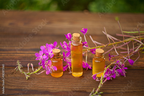 Essence of lavender flowers on table in beautiful glass Bottle