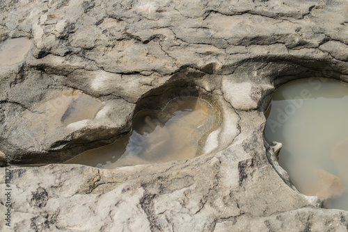 Photos Indentations in the rocks are filled with rain water
