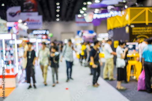 Abstract blurred people walking and shopping in Exhibition Hall. photo
