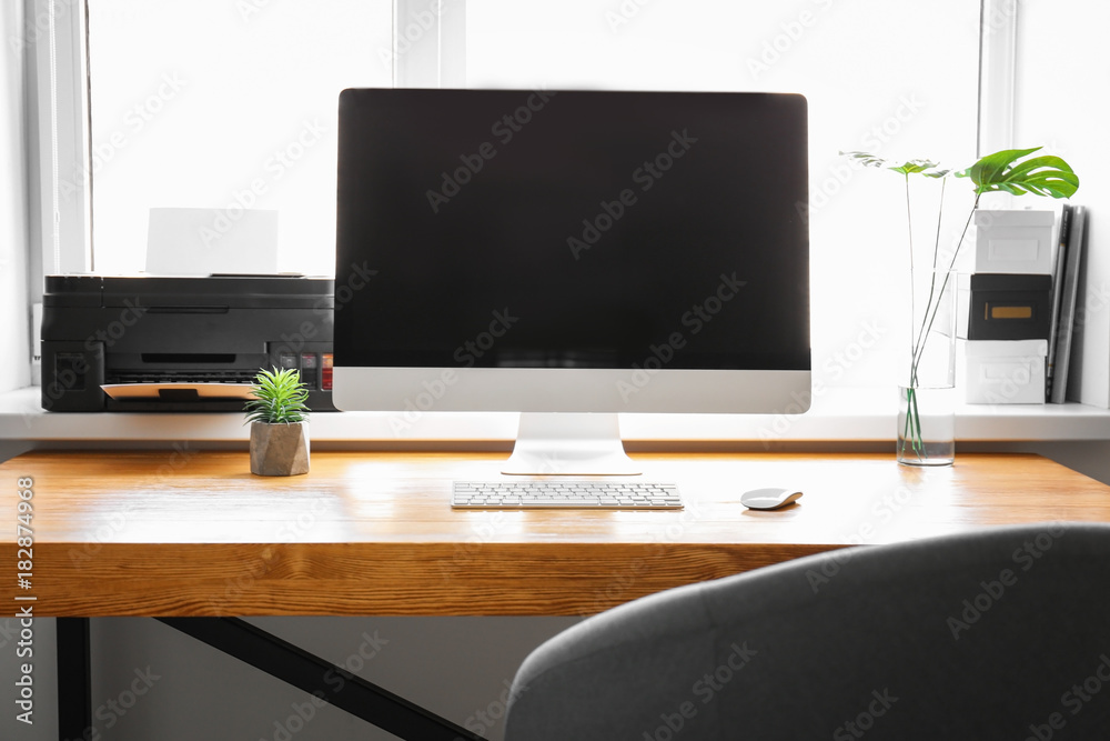 Comfortable workplace with computer monitor on table in office Comfortable workplace with computer monitor on table in office